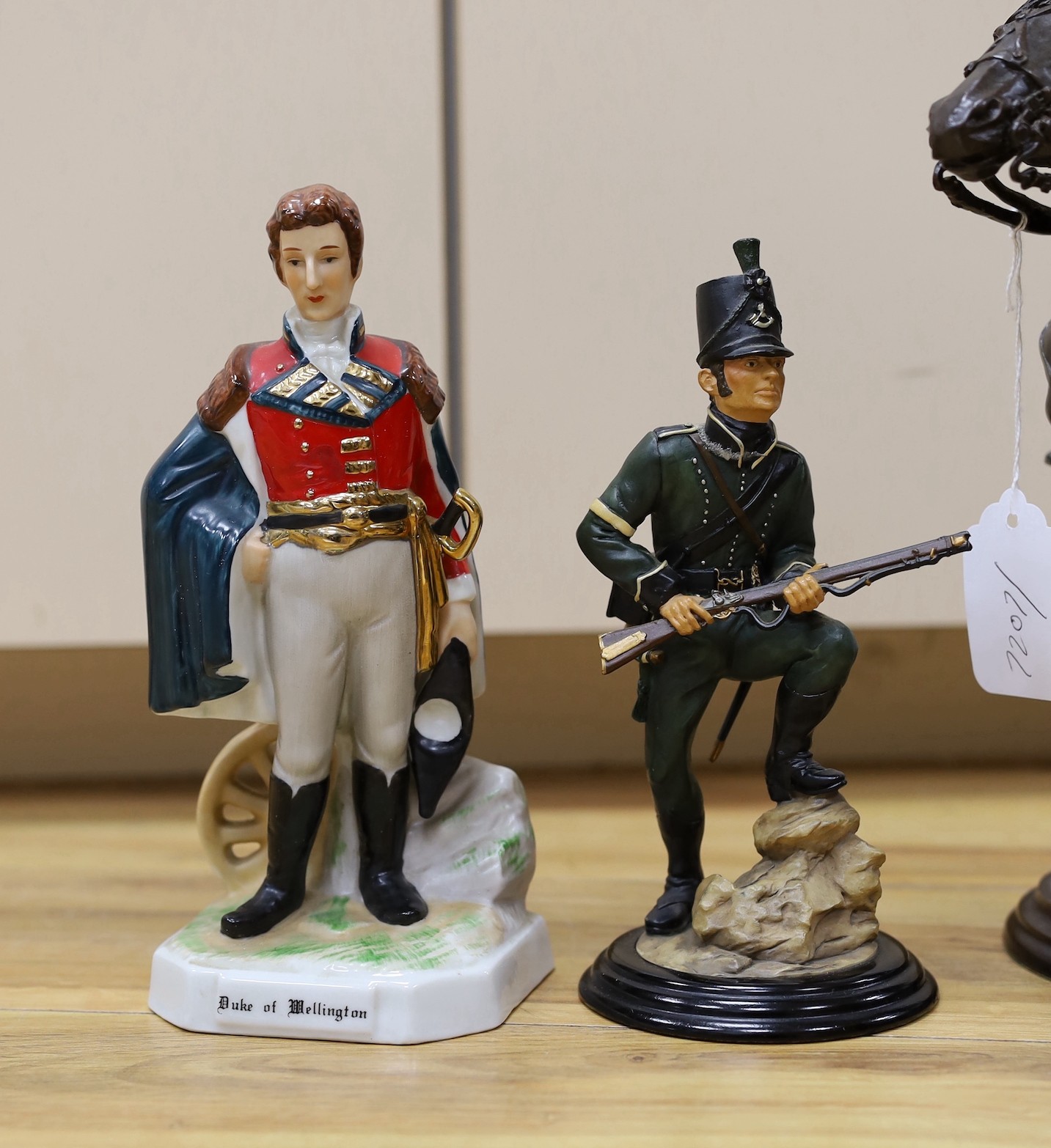 Duke of Wellington and Napoleonic war interest – a group of composition and ceramic figures of soldiers, a model of a cannon, a composition group of Wellington on horseback etc.